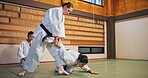 Karate, self defense and submission with people in dojo for demonstration, fitness or training. Challenge, martial arts or technique with Sensei and student in Japan for combat, fighting or sports