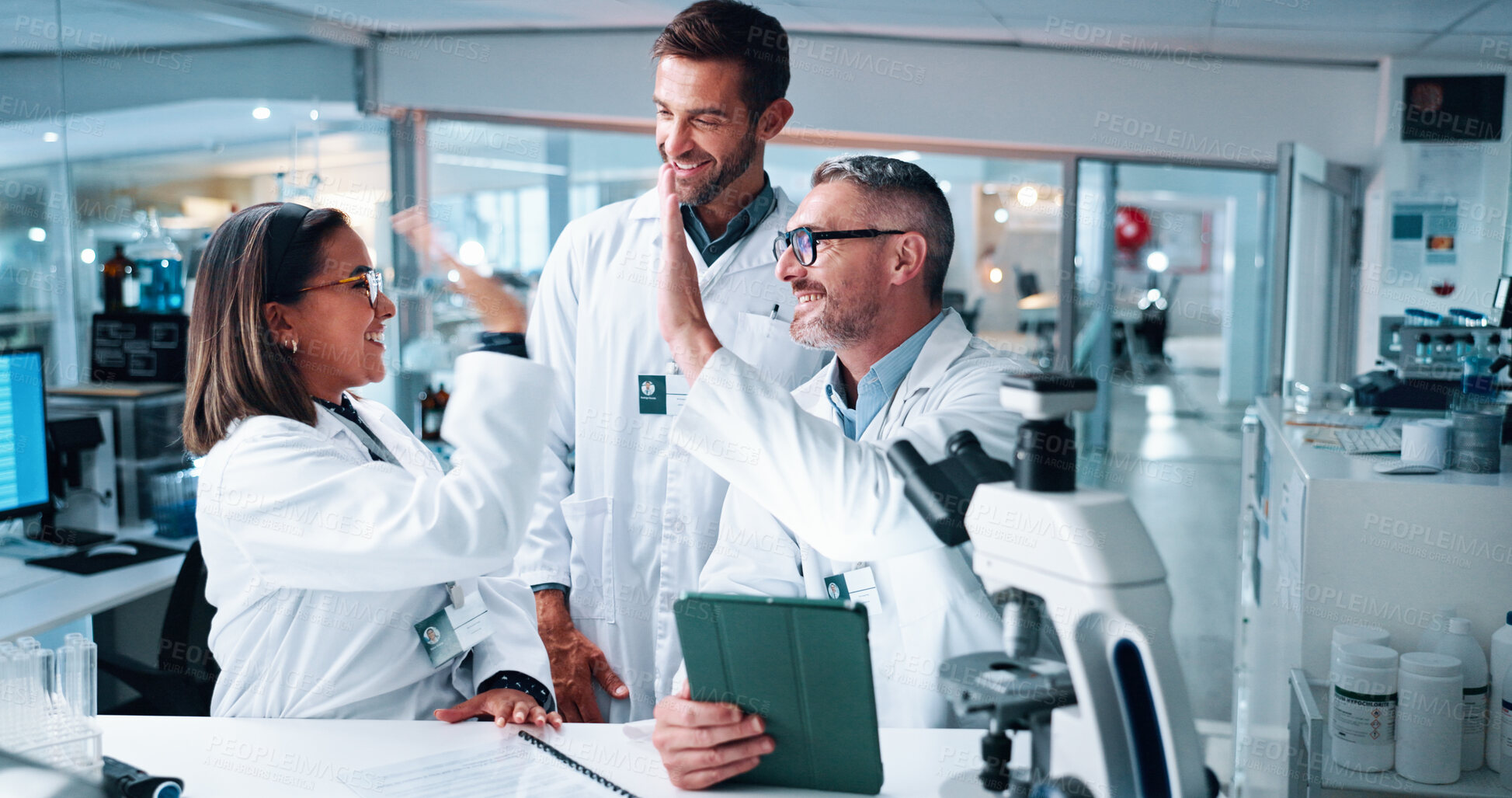 Buy stock photo High five, science and success with people in laboratory together for breakthrough or development. Tablet, microscope and motivation with research team in clinical trial for celebration or target