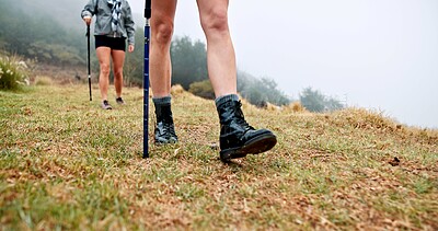Buy stock photo Trekking pole, feet and walking on mountain for travel adventure, cardio workout and expedition. Fitness, shoes of people and hiking with balance outdoor for holiday exploration, exercise or wellness
