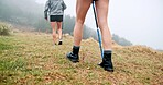 Trekking pole, feet and walking outdoor for travel adventure, cardio exercise or fitness journey. Fog, back of people and hiking with balance on mountain for holiday exploration, workout or wellness