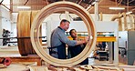 Man, woman and carpenter with wood at factory for discussion, inspection or guide with leader at plant. People, help and training with feedback, manufacturing or collaboration at industrial warehouse