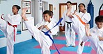 Exercise, karate and sports with kids in class for combat, fighting or self defense training. Development, fitness or growth with children and sensei in dojo for martial arts lesson or practice