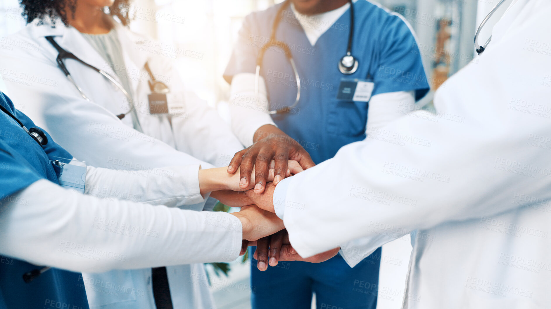Buy stock photo Healthcare, nurses and doctors with hands for huddle, teamwork and motivation in hospital for work. People, employees or medical diversity with stack to celebrate, solidarity or collaboration support