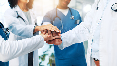 Buy stock photo Hospital, nurses and doctors with hands for huddle, teamwork and motivation in clinic for work. People, employees and healthcare diversity with stack for medical, solidarity and collaboration support