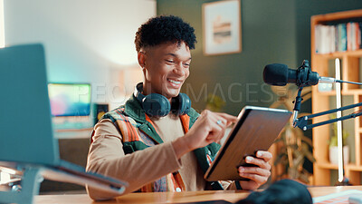 Buy stock photo Man, streamer and tablet in home with mic, typing and smile with script editing for video production. Influencer, happy and app for chat with fans, click or subscription list on social media at house