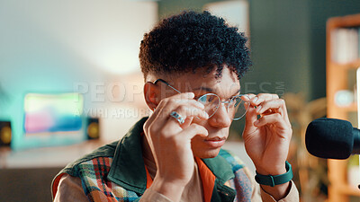 Buy stock photo Serious, podcaster and man with glasses, mic or ready for live streaming of interview or production. Studio, content creator and person with tech for podcast, broadcast and hosting of talk show