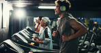 Fitness, man and running on treadmill with headphones at night for agility training, speed development or cardio music. Athlete, evening workout or playlist for calorie burning, endurance or wellness