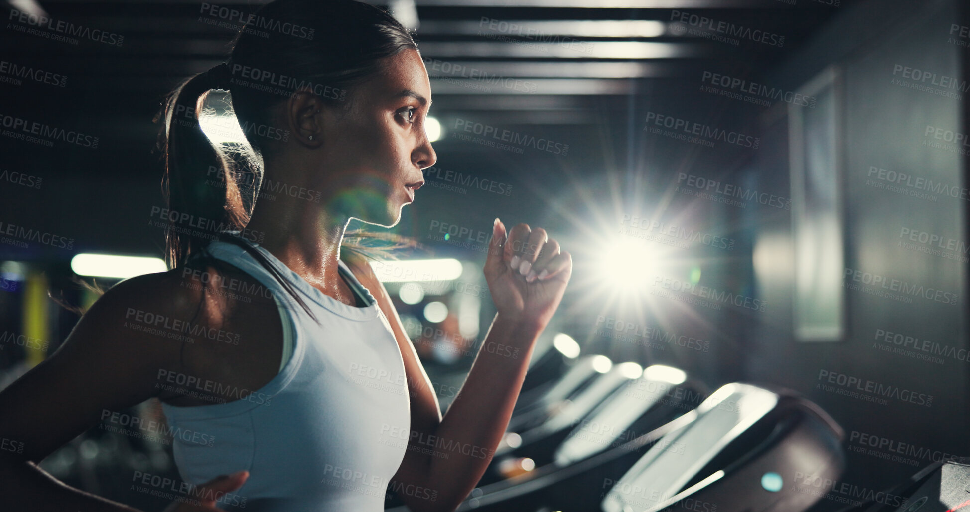 Buy stock photo Workout, girl and running on treadmill in gym at night for fitness, training and burning calories. Flare, late exercise and athlete with breathing for intense cardio, endurance challenge and wellness