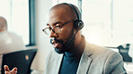 Businessman, consultant and talking with headset at office for customer service or online advice. Man, employee or agent speaking with mic for telecommunications or virtual assistance at call center