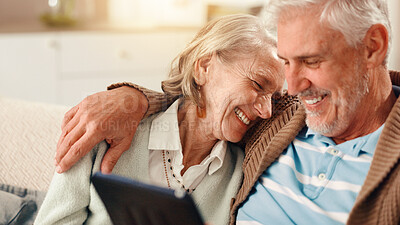 Buy stock photo Senior couple, tablet and laugh on sofa in home with hug, happy and relax with film in living room. Elderly man, woman and digital touchscreen with app for funny movies, comedy or video in retirement
