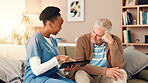 Tablet, talking and nurse with senior man on sofa for medical service, consulting and help. Retirement home, healthcare and caregiver with patient on tech for results, diagnosis and assisted living