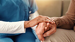 Holding hands, closeup and senior person with nurse on sofa for comfort, empathy and support. Retirement home, healthcare and caregiver with patient for care, help and compassion in assisted living