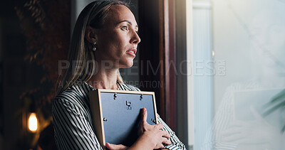 Buy stock photo Woman, picture and sad by window with memory, mourning and regret or loss of loved one at home. Female person, widow and hug photo frame with sorrow at house with nostalgia, lonely and reflection