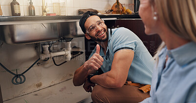 Buy stock photo Plumber, woman and thumbs up for repair by kitchen sink for leak, drain and maintenance in home. Handyman, client and sign for yes, finished and smile for services with deal for solution at apartment