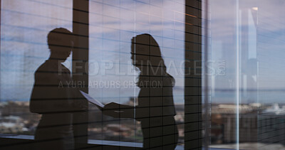 Buy stock photo Discussion, shadow and business women in office by window with documents for finance report. Meeting, paperwork and silhouette of female financial advisors with company budget planning in workplace.