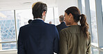 Business, people and walking with discussion in office for meeting brief, finance feedback and back. Financial manager, consultant and teamwork for project management, planning and professional chat