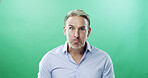 Sulking, portrait and businessman with negative emotion in studio or oops, mistake and upset. Face expression, unhappy and mature professional with raised eyebrow, anxiety and green background