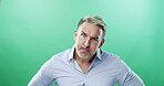 Anger, portrait and businessman with raised eyebrow in studio or frustrated, stress and upset. Face expression, unhappy and mature professional with frown, annoyed and conflict on green background