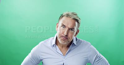 Buy stock photo Anger, portrait and businessman with raised eyebrow in studio or frustrated, stress and upset. Face expression, unhappy and mature professional with frown, annoyed and conflict on green background