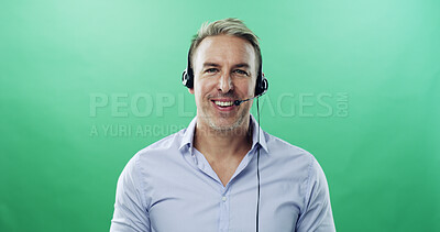 Buy stock photo Happy man, portrait and consultant with headset on green background for communication in studio. Male person, agent or model with smile or mic for online advice or customer service on mockup space
