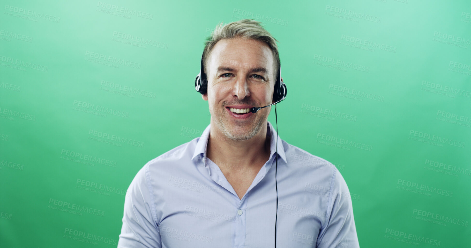 Buy stock photo Happy man, portrait and consultant with headset on green background for communication in studio. Male person, agent or model with smile or mic for online advice or customer service on mockup space