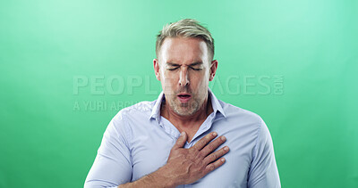 Buy stock photo Chest pain, sick and man in studio, coughing and tuberculosis on green background. Person, illness and model with stress, breathing and asthma with heartburn, allergy and emergency with heart attack