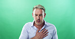 Chest pain, sick and man in studio, heart attack and tuberculosis on green background. Person, illness and model with stress, breathing and asthma with heartburn, allergy and medical emergency