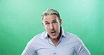 Anger, portrait and businessman with speaking in studio with frustrated, stress and upset. Face expression, unhappy and mature professional with frown, annoyed and conflict on green background