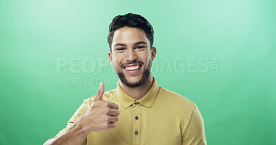 Buy stock photo Portrait, man and smile with thumbs up in studio for agreement, thank you and good news. Mockup space, person and like emoji of yes feedback, vote sign and opinion of announcement on green background