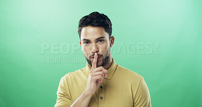 Buy stock photo Portrait, man and quiet for secret in studio for gossip, privacy sign and silence for rumor. Person, mockup space and hand gesture for mystery, confidential news and announcement on green background