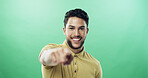 Portrait, man and pointing to you in studio for selection, decision and choice for winner vote. Mockup space, person and hand gesture for invitation, join us and opinion for offer on green background