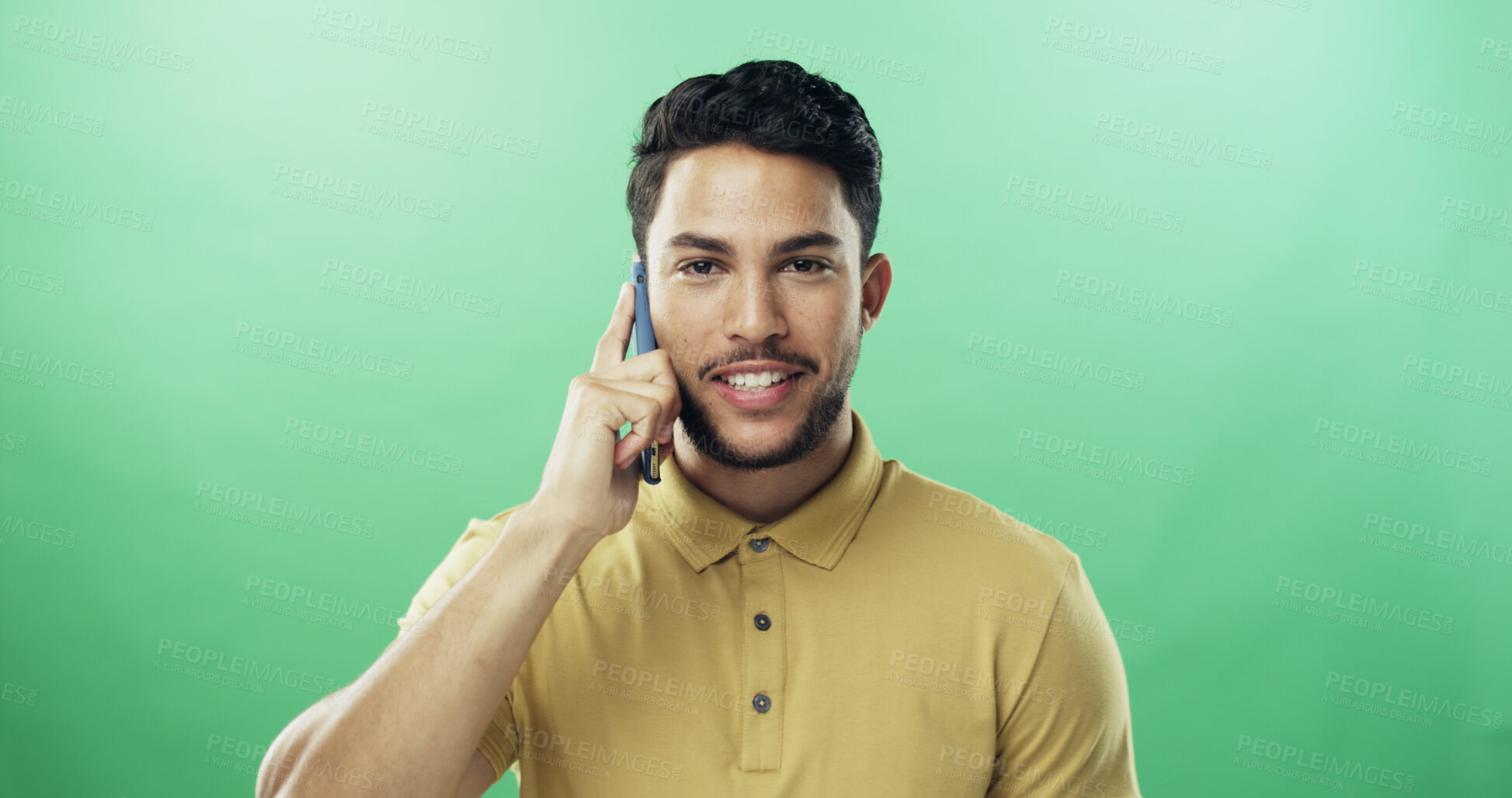 Buy stock photo Man, phone call and portrait in studio with smile for talk, chat and connection by green background. Person, smartphone and conversation with mobile network, happy and mockup space in Costa Rica