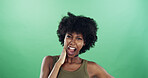 Portrait, funny face and black woman in studio, expression and confident personality on green background. African person, pride or happy model with goofy emoji, silly and smile with humor or reaction