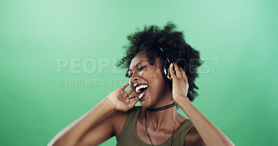 Buy stock photo Dance, music and singing with black woman on green background for energy, excitement or streaming. Headphones, radio and space with happy dancer person in studio for audio subscription or rhythm
