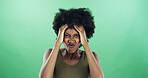 Frustration, emotions and black woman in studio with reaction for mistake, fail or crisis problem. Annoyed, upset and African person with regret for rage, fear or mental health by green background.