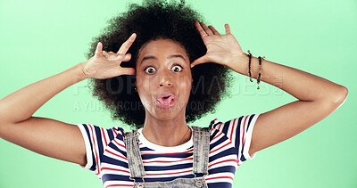 Buy stock photo Portrait, funny and black woman in studio, silly and facial expression on green background. African person, space and happy model with confident personality, crazy and playful attitude with fun