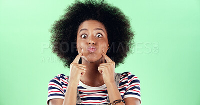 Buy stock photo Portrait, funny and black woman in studio, crazy and facial expression on green background. African person, space and happy model with confident personality, silly and playful attitude with fun