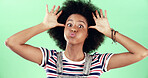 Portrait, funny and black woman in studio, emoji and facial expression on green background. African person, silly and happy model with confident personality, crazy and playful attitude with humor