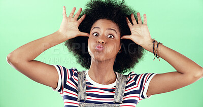 Buy stock photo Portrait, funny and black woman in studio, emoji and facial expression on green background. African person, silly and happy model with confident personality, crazy and playful attitude with humor