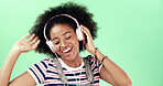Studio, green screen and woman with music for dancing, movement and listening to audio track. African female person, model and energy with headset for podcast, hip hop and happy by mockup background