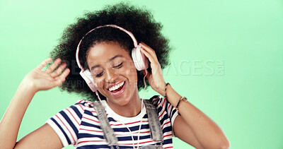 Buy stock photo Studio, green screen and woman with music for dancing, movement and listening to audio track. African female person, model or energy with headset for streaming, hip hop and happy by mockup background