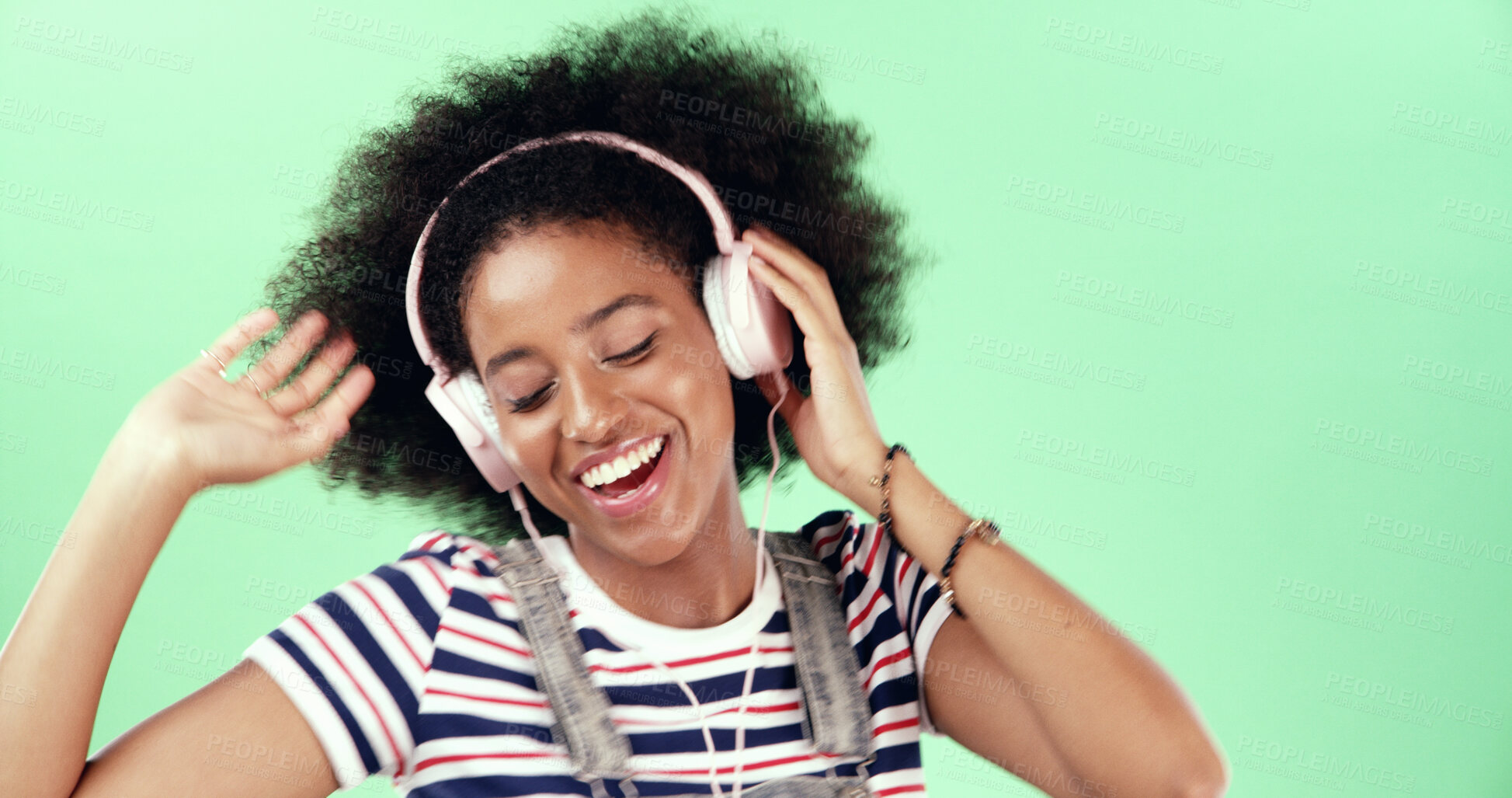 Buy stock photo Studio, green screen and woman with music for dancing, movement and listening to audio track. African female person, model or energy with headset for streaming, hip hop and happy by mockup background