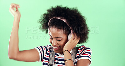 Buy stock photo Green background, smile and woman with headset for dancing, movement and listening to audio track. African female person, model and energy with rhythm for podcast, hip hop and music in studio mockup
