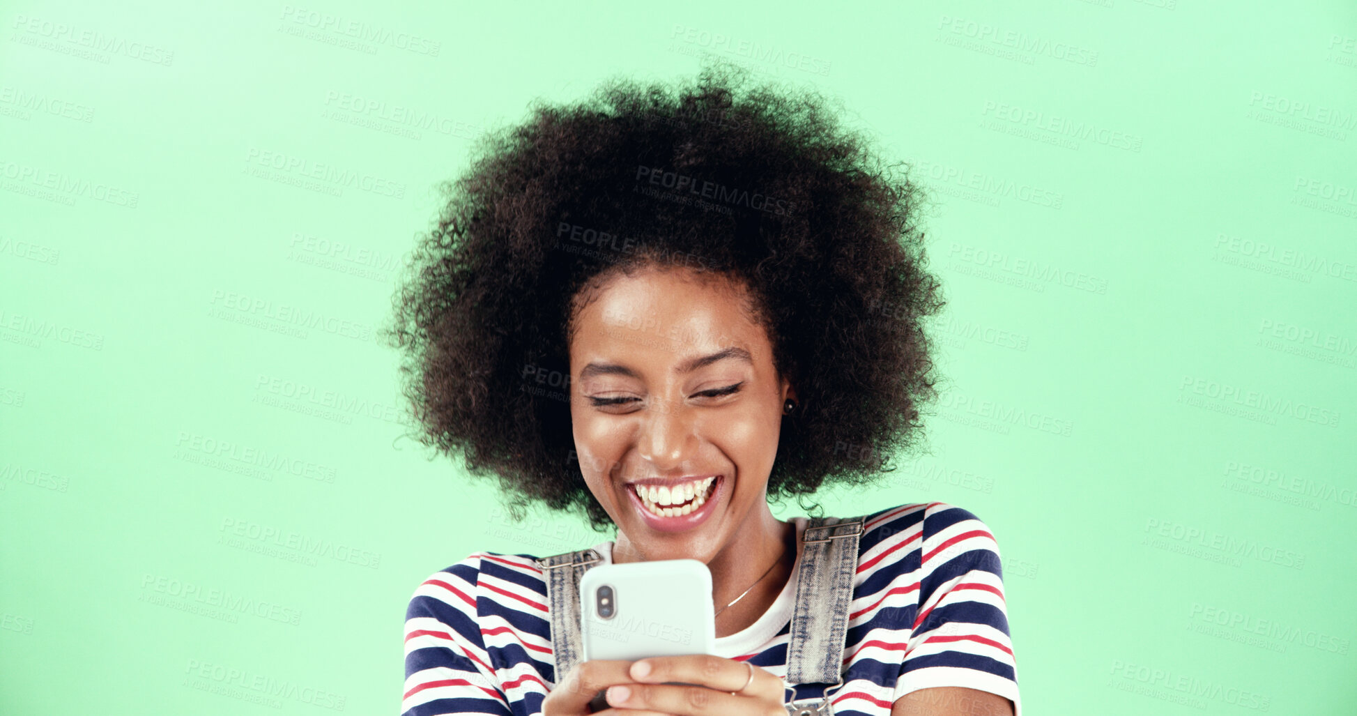 Buy stock photo Black woman, smartphone and laughing at funny joke in studio with gossip, communication and humor online. Contact, comedy ebook or comic space on website for happy female person on green background