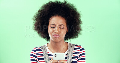 Buy stock photo Black woman, smartphone and frown with confused face in studio, scam or notification error with internet glitch. Email spam, fake news or web 404 on mobile app for connection fail on green background