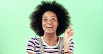 Thinking, black woman and pointing with idea in studio for solution, answer or afro with a smile. Excited, female person and aha moment on green background with space, positive and problem solving