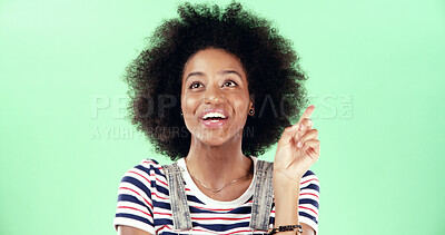 Buy stock photo Thinking, black woman and pointing with idea in studio for solution, answer or afro with a smile. Excited, female person and aha moment on green background with space, positive and problem solving