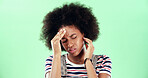 Green screen, headache and black woman on studio background with stress, migraine or pain. Frustrated, angry and burnout with temple massage, student person and sick with health risk for chromakey