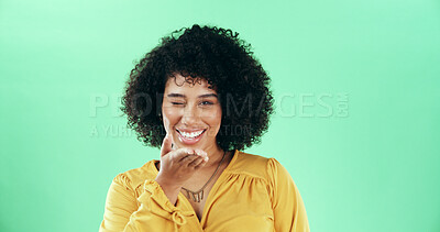Buy stock photo Portrait, blow kiss and woman in studio, winking and confident personality on green background. Face, happy person and model with hand gesture, smile and symbol with love, emoji and romantic