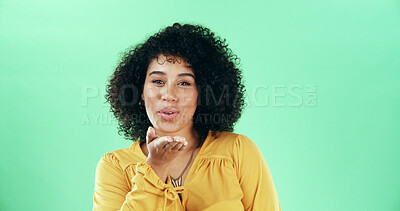 Buy stock photo Portrait, blowing kiss and woman in studio, smile and confident personality on green background. Face, happy person and model with hand gesture, kindness and symbol with love, flirting and romance